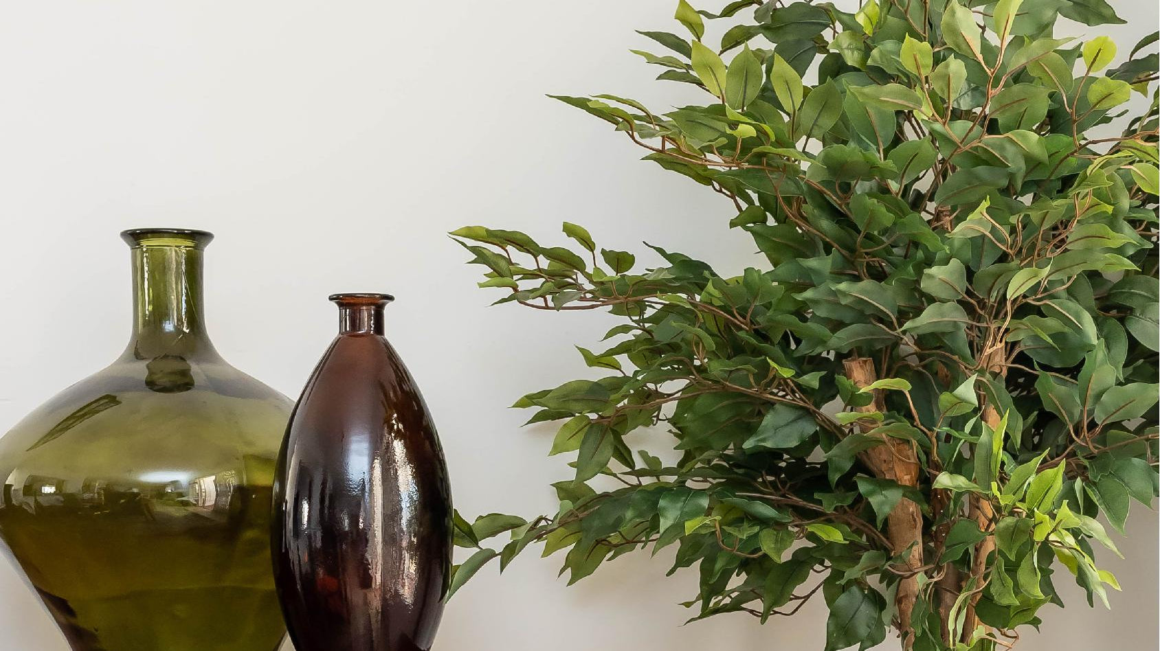 Artificial tree in a dining room with decorative vases