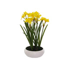 Artificial yellow daffodil plant in white ceramic pot