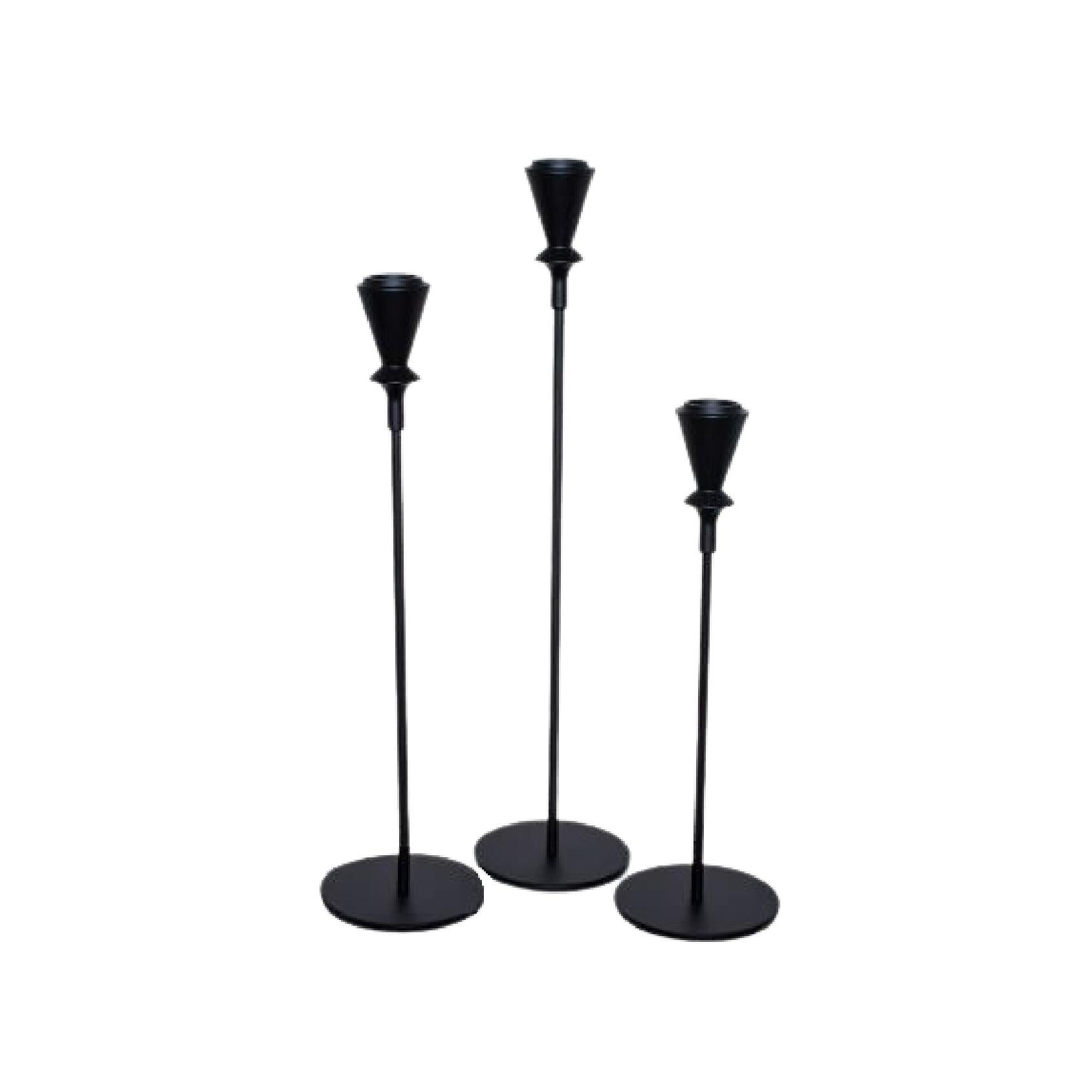 Set of three black metal candlesticks in varying heights