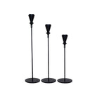 Set of three black metal candlesticks in varying heights