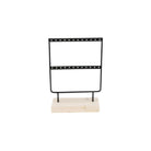 Black metal earring display stand with two rows of holes, mounted on a natural wood base