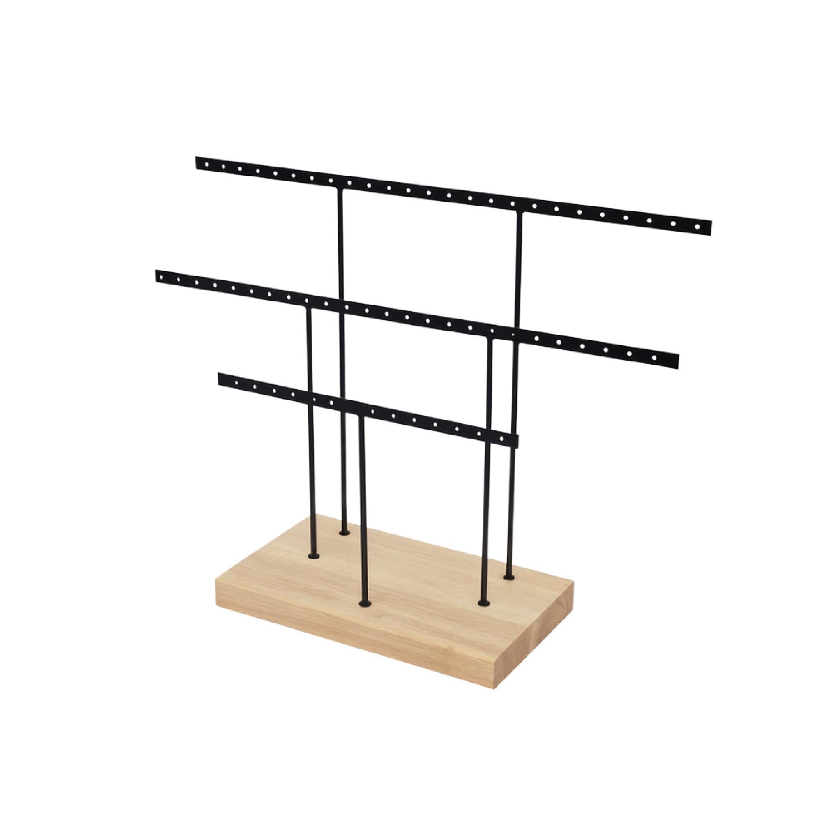 Black earring display stand with multiple tiers on a wooden base