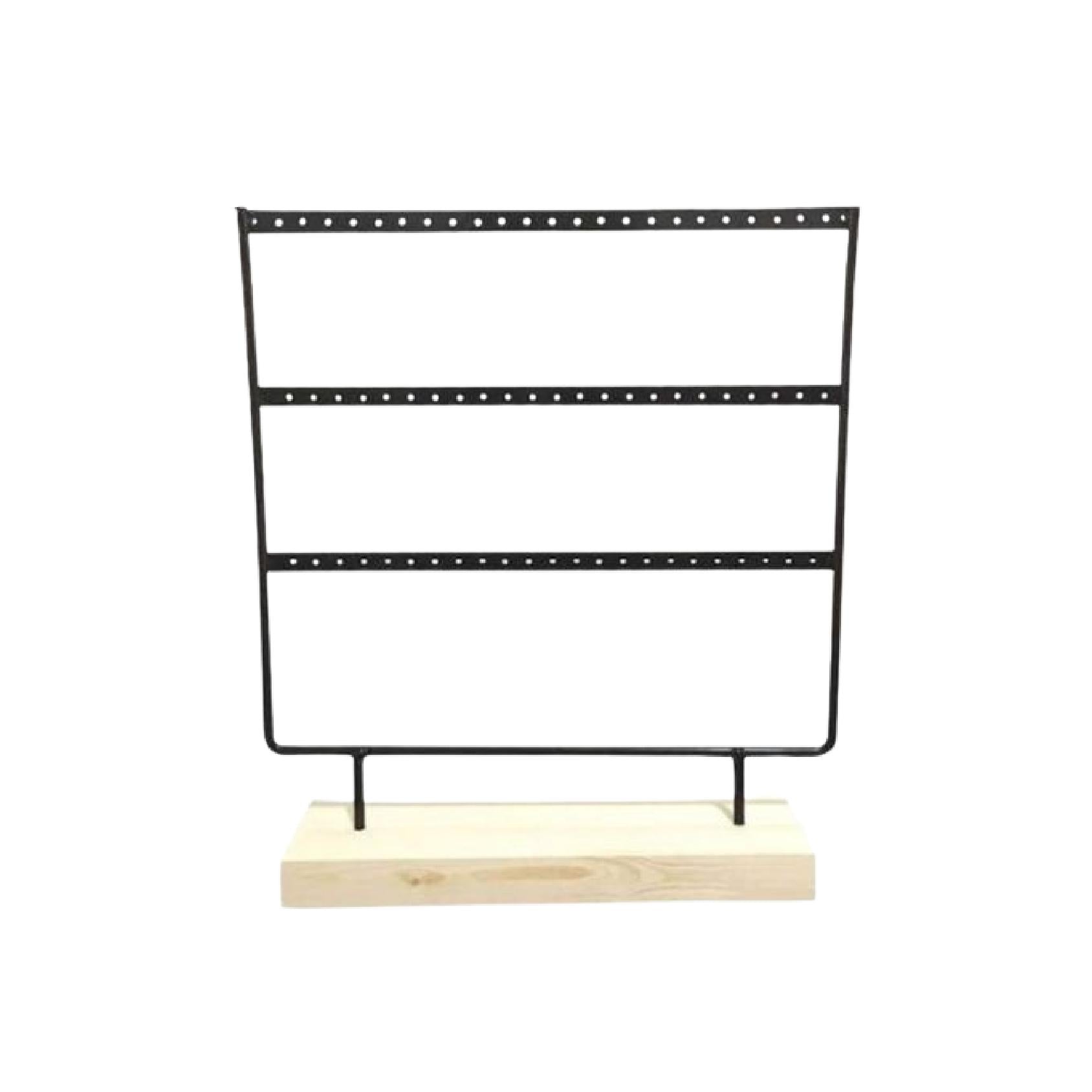 Black metal earring holder with three rows on a natural wood base