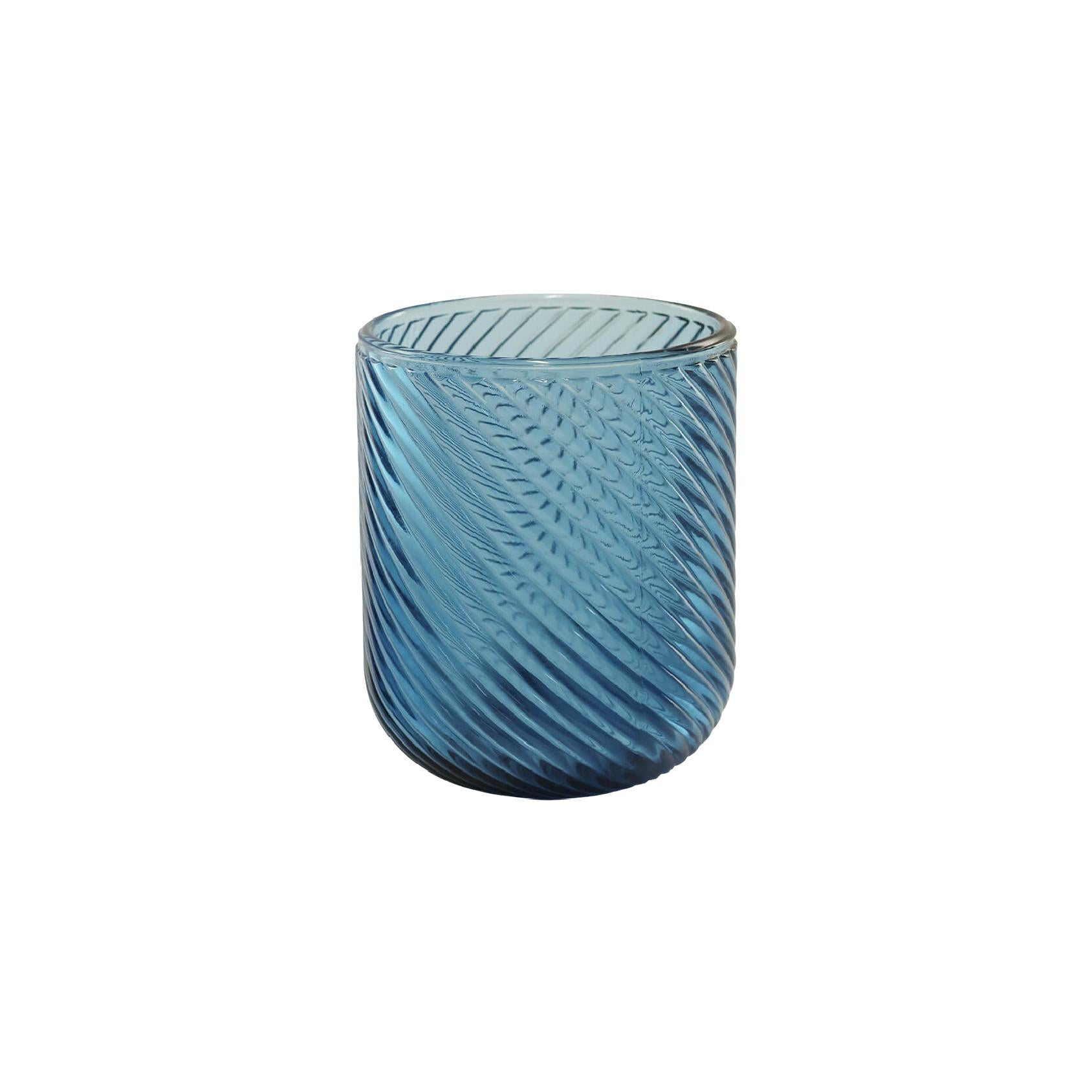 Blue textured glass tumbler on a white background