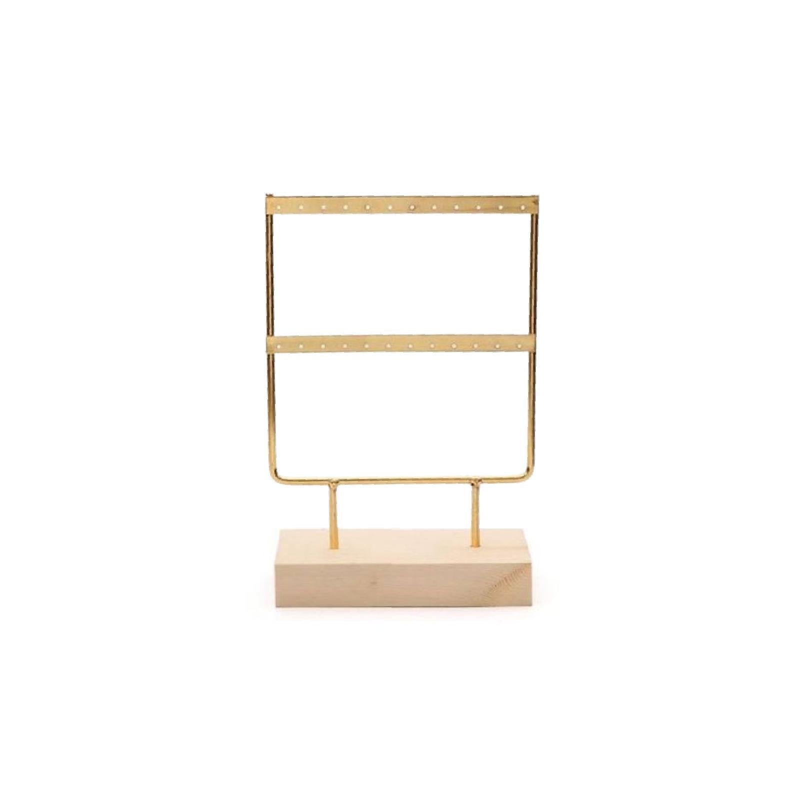 A two-tier gold and natural wood earring display with metal rods on a wooden base