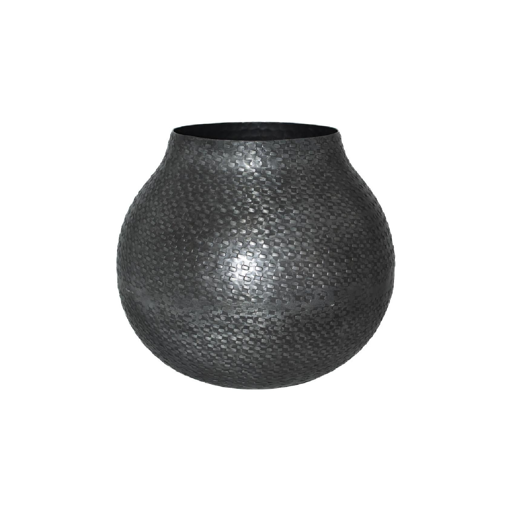 Dark grey round metal vase with hammered textured finish on a white background