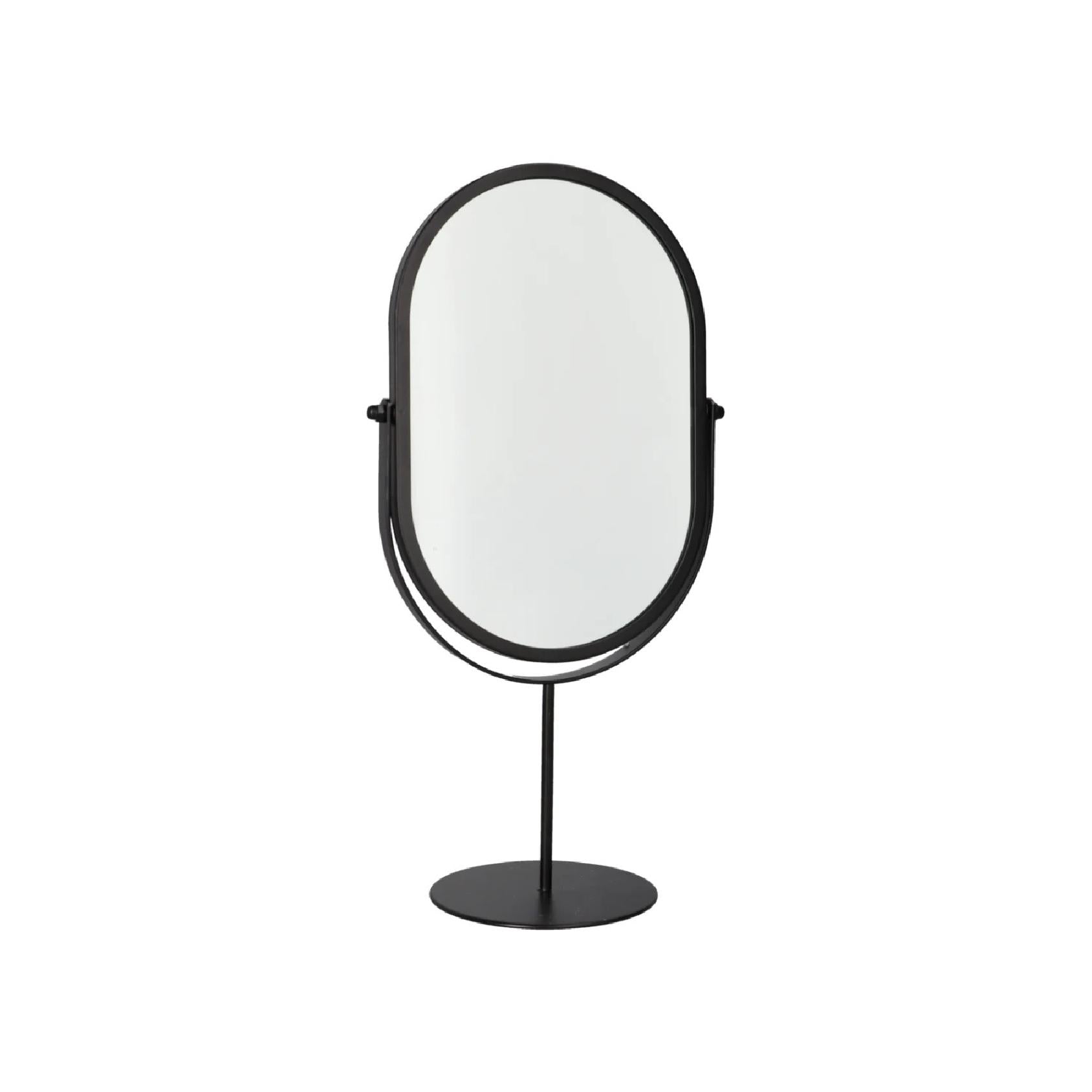 Oval black mirror on pedestal