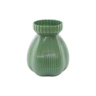 Sage green ribbed glass vase on a white background