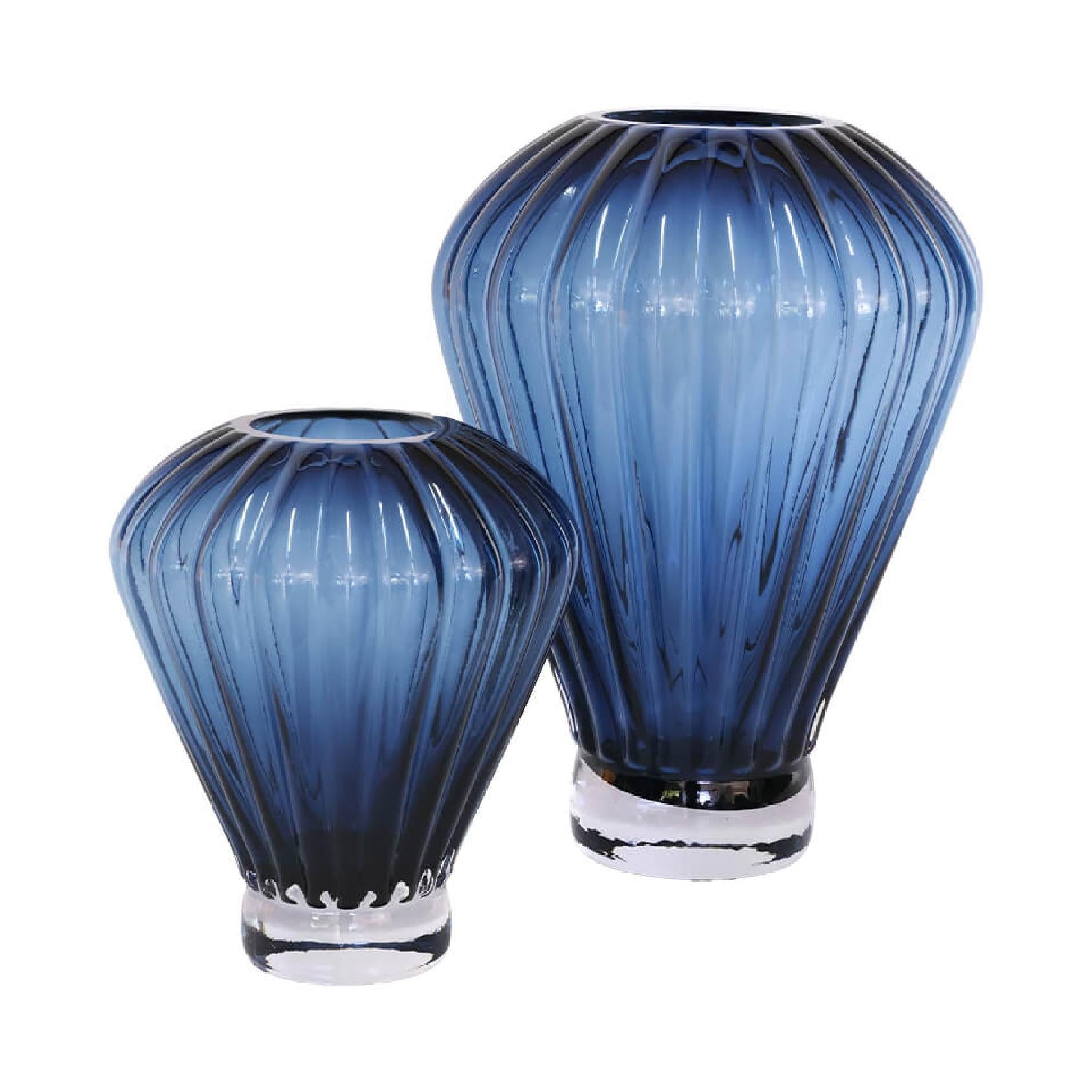 Set of two blue fluted glass vases with vertical lines and pedestal bases