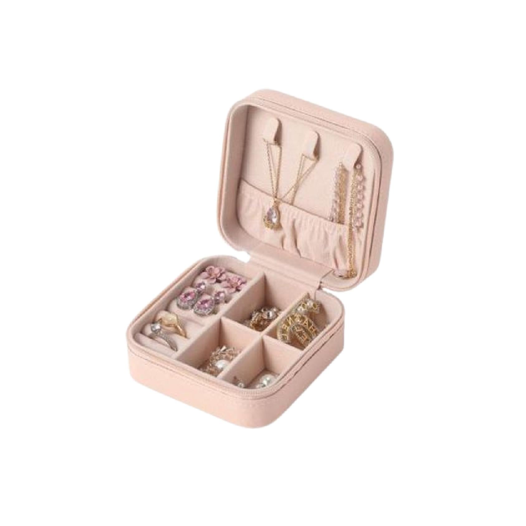 Pink square zip-around jewellery travel case filled with jewellery