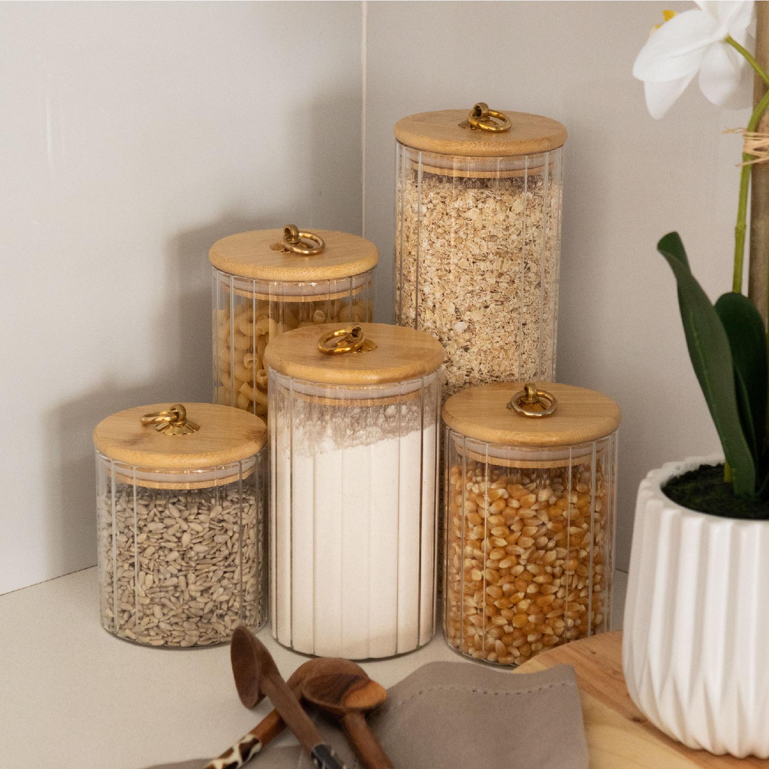 Wave glass storage jars styled in a kitchen with pantry staples & bamboo lids