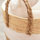 Close-up of a woven basket with a braided handle