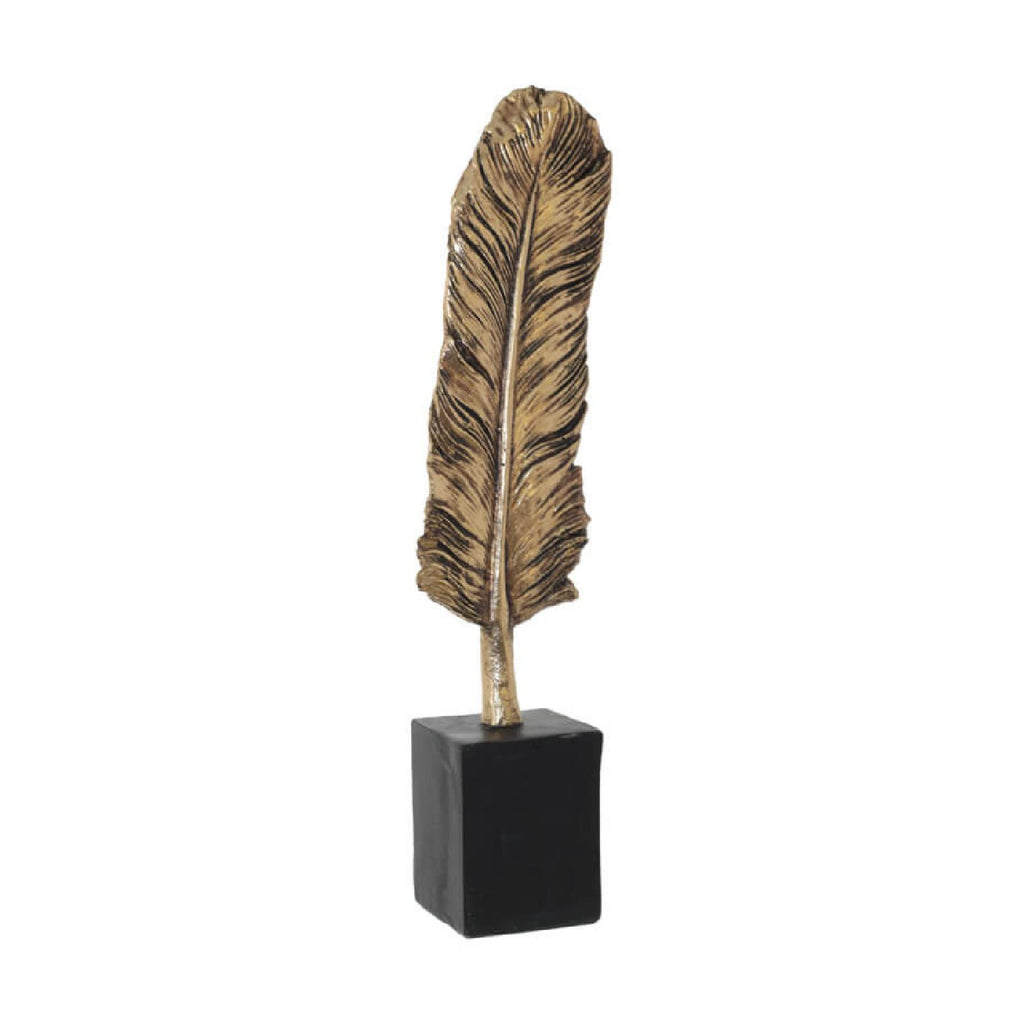 Decorative gold feather on wooden plinth