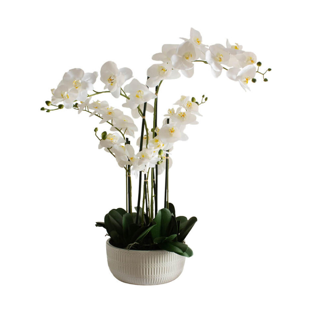Artificial white orchid in beige ceramic pot