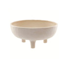 A beige ceramic decorative bowl with a textured exterior and three short legs