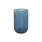 Blue glass tumbler with a textured design on a white background