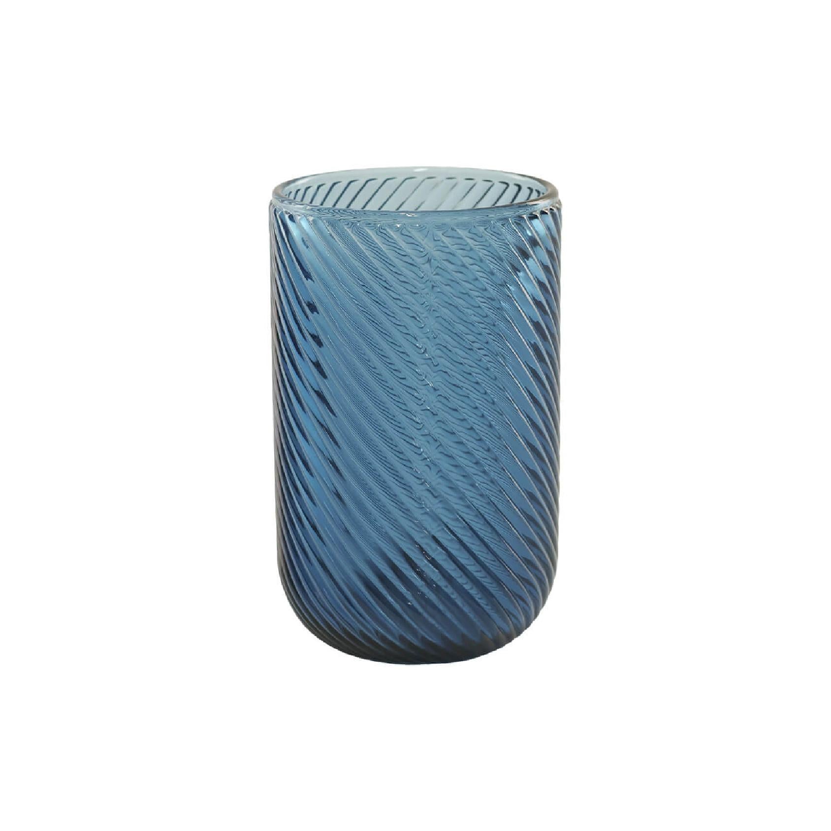 Blue glass tumbler with a textured design on a white background