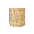 A cylindrical woven basket made from natural seagrass