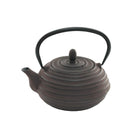 A dark brown cast iron teapot with circular ridges on the body and a black metal handle