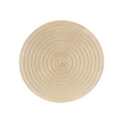 A round vinyl placemat in a champagne colour