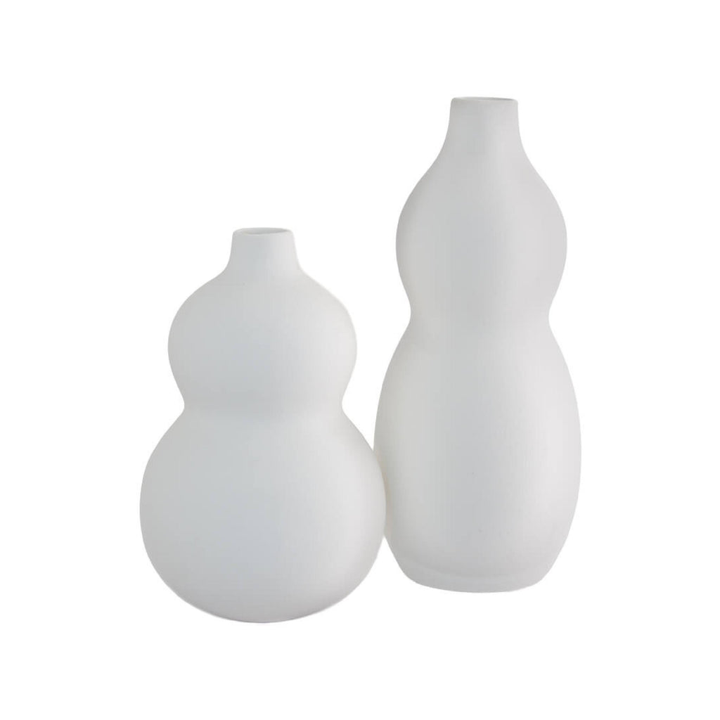 Matching white curved ceramic vases