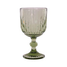 A green wine glass with a vertical ribbed pattern