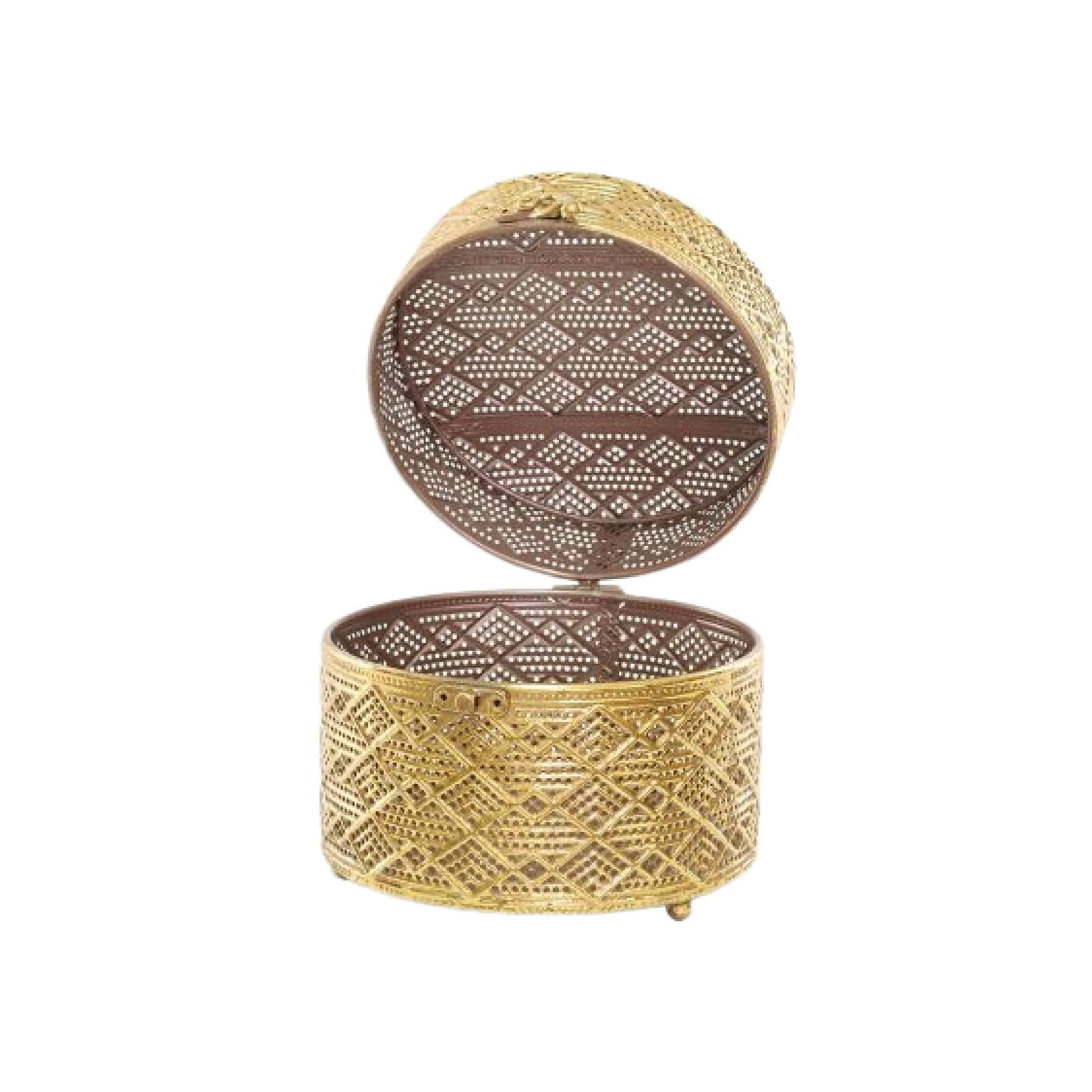Gold lattice metal trinket box with hinged lid opened on a white background