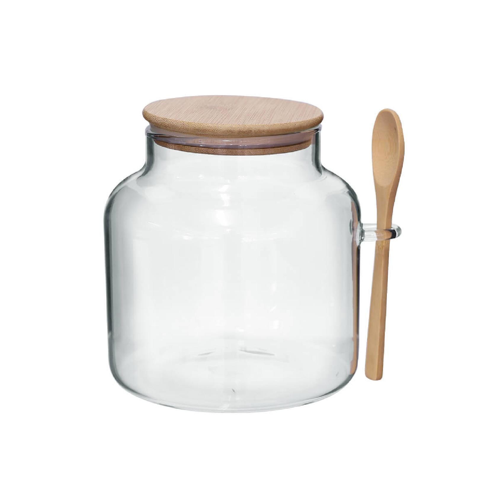Large glass storage jar with matching wooden lid and spoon