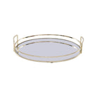 A round tray with a gold metal frame and a mirrored base