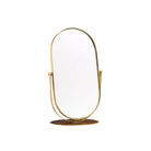 Gold oval mirror on a pedestal 