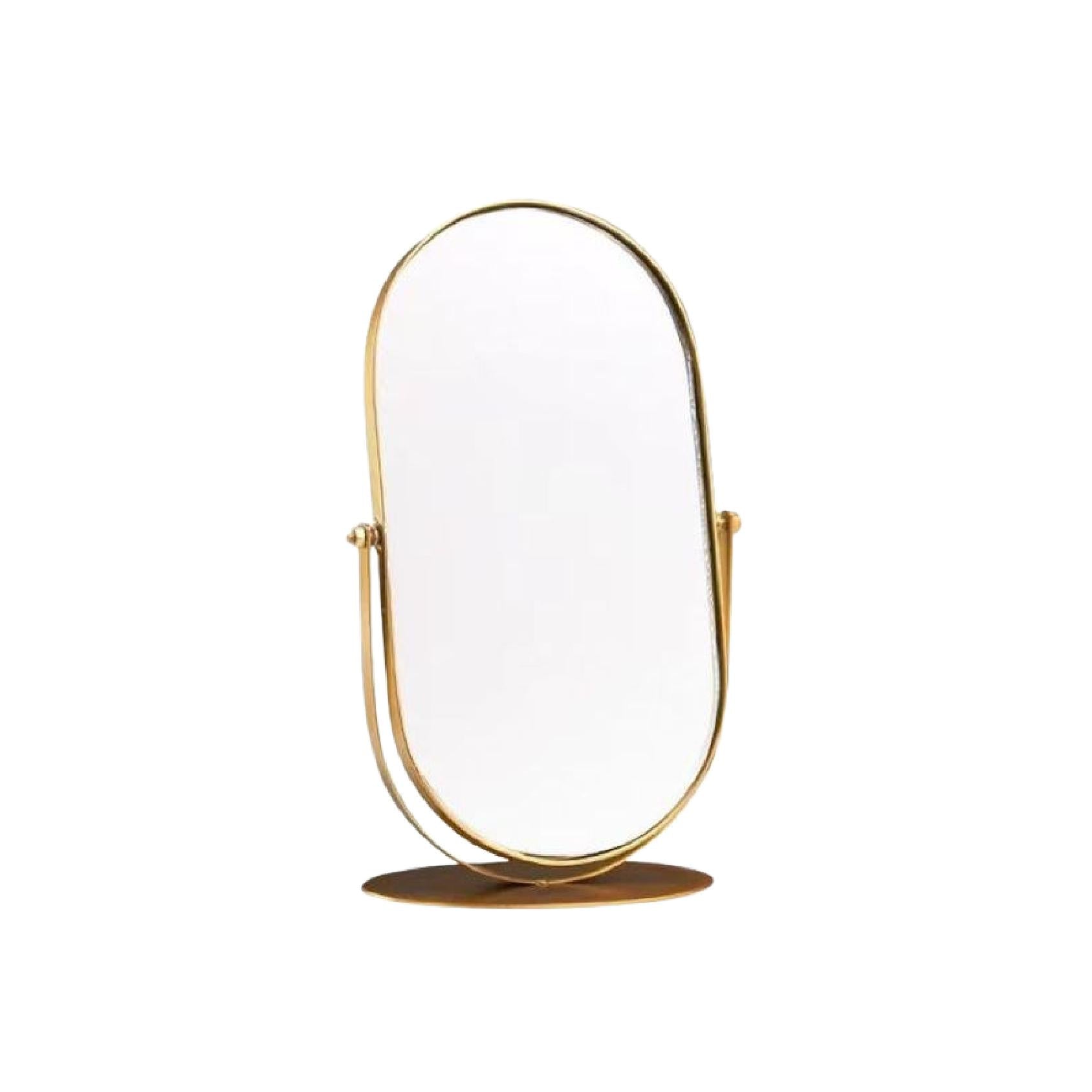 Gold oval mirror on a pedestal 