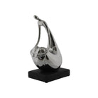 A modern abstract silver metallic sculpture of a woman kneeling, set on a black rectangular base
