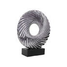 Decorative sculpture with a spiral design on a black base