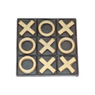 A 3x3 tic-tac-toe game board with a dark charcoal grey background and raised metallic gold 'X' and 'O' pieces