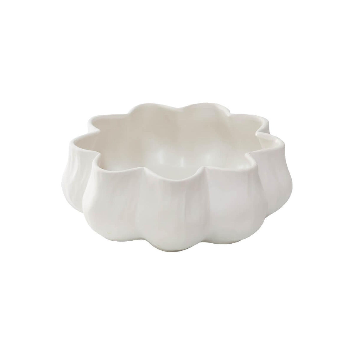 A white ceramic bowl with a scalloped, flower-like rim
