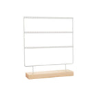 White metal earring stand with a natural wood base