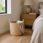 Natural woven storage basket styled in a bedroom