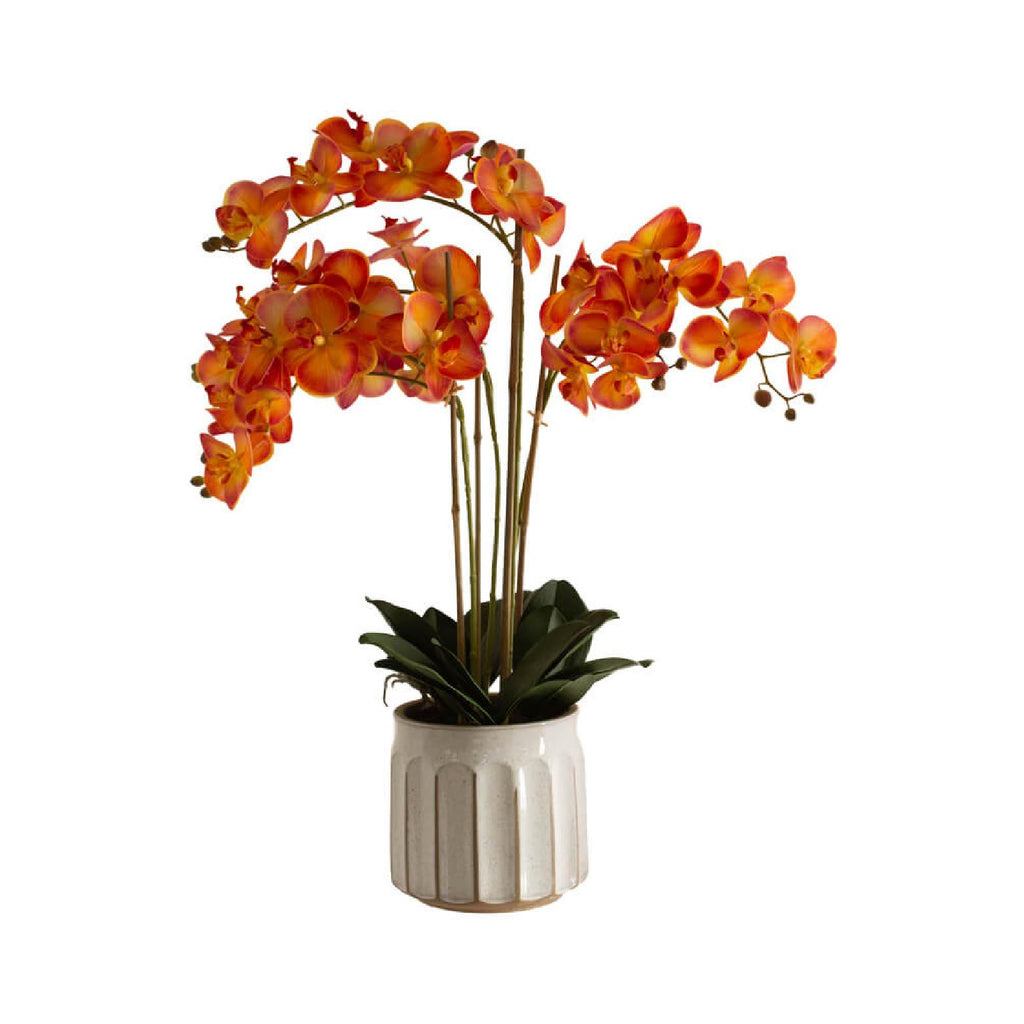 Artificial orange orchid in a beige ceramic pot