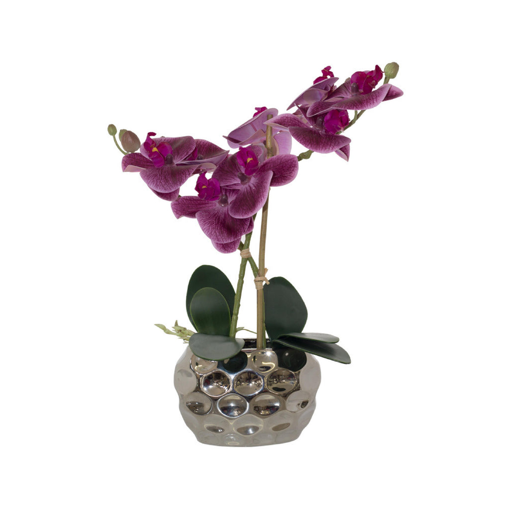 Artificial purple orchid in a decorative ceramic pot