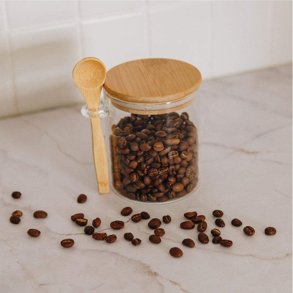 Glass storage jar with a bamboo lid and spoon